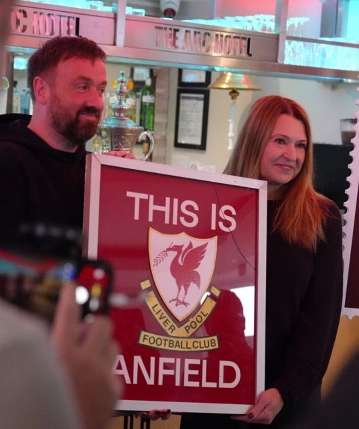 Chris Carline and Karen Gill at the unveiling of the original 'This Is Anfield' sign at its new home, The ARC Hotel on Anfield Road