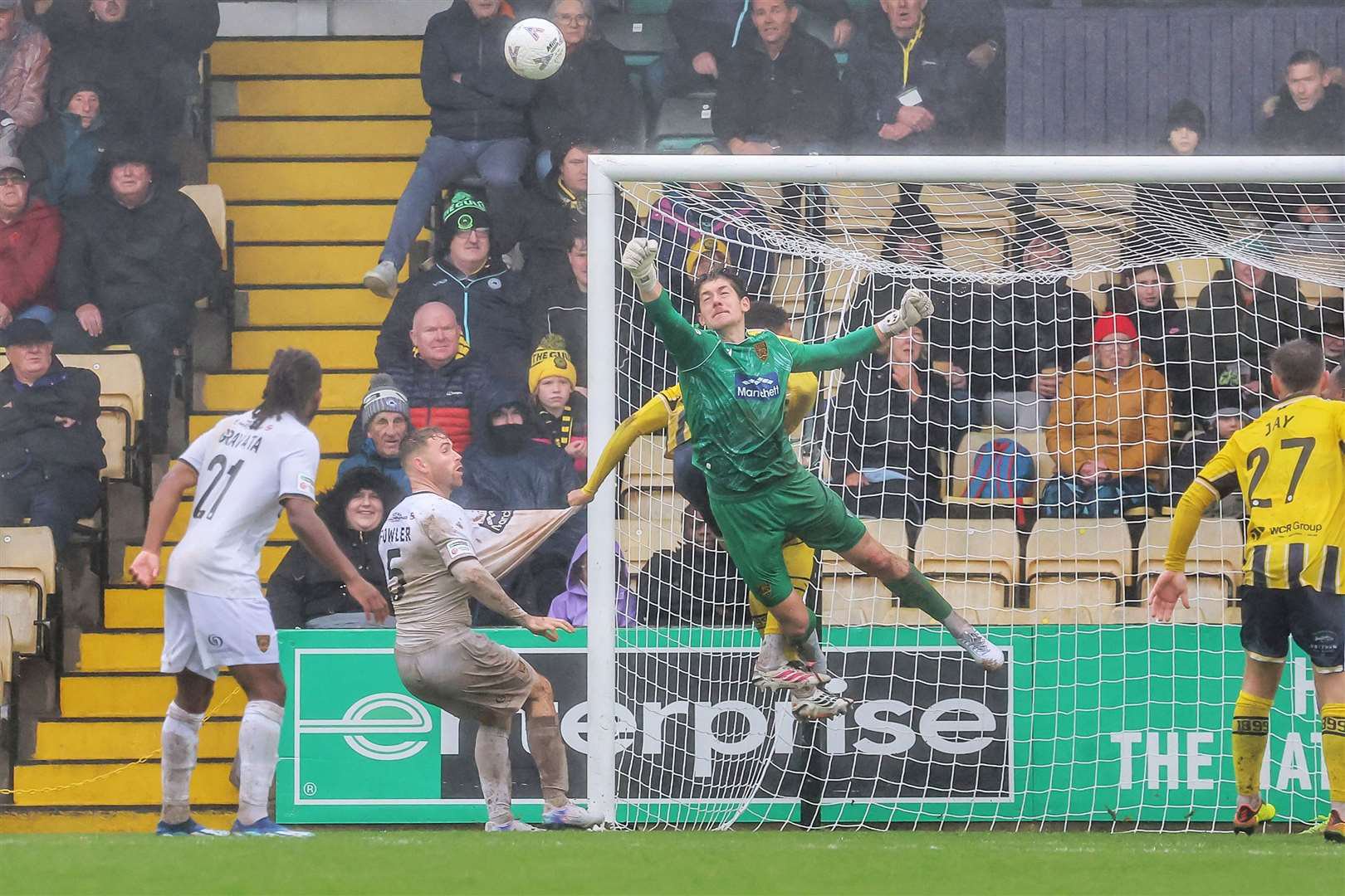 Maidstone goalkeeper Lenny Holden punches clear under pressure. Picture: Helen Cooper