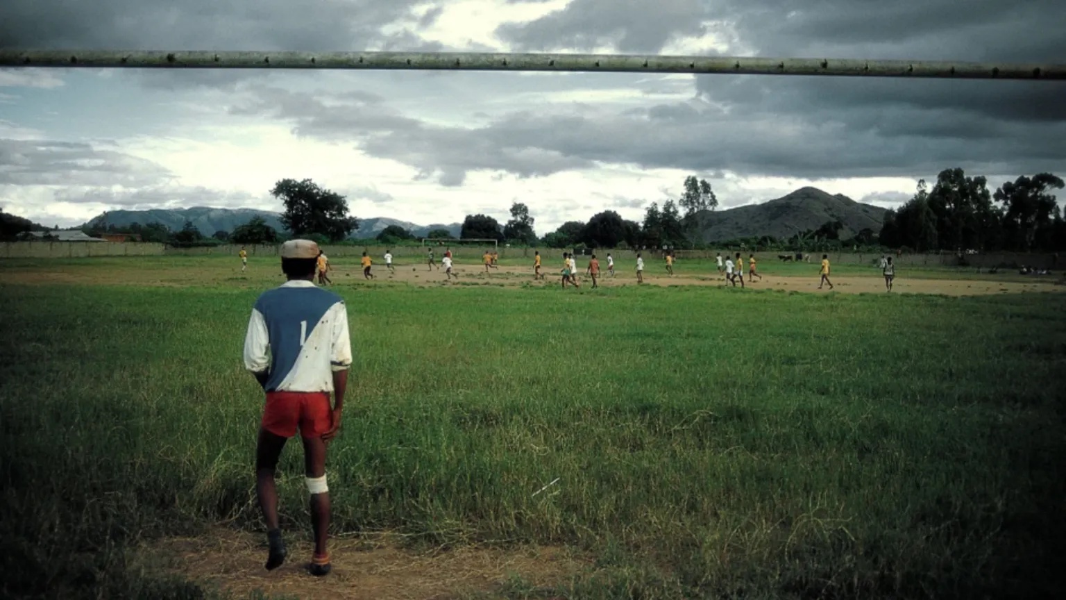 Peter Robinson/Alamy Peter's image of a goalie standing in long grass in Fianarantsoa, Madagascar, in 
19 April 1987. There is a team full of players chasing the ball in the background