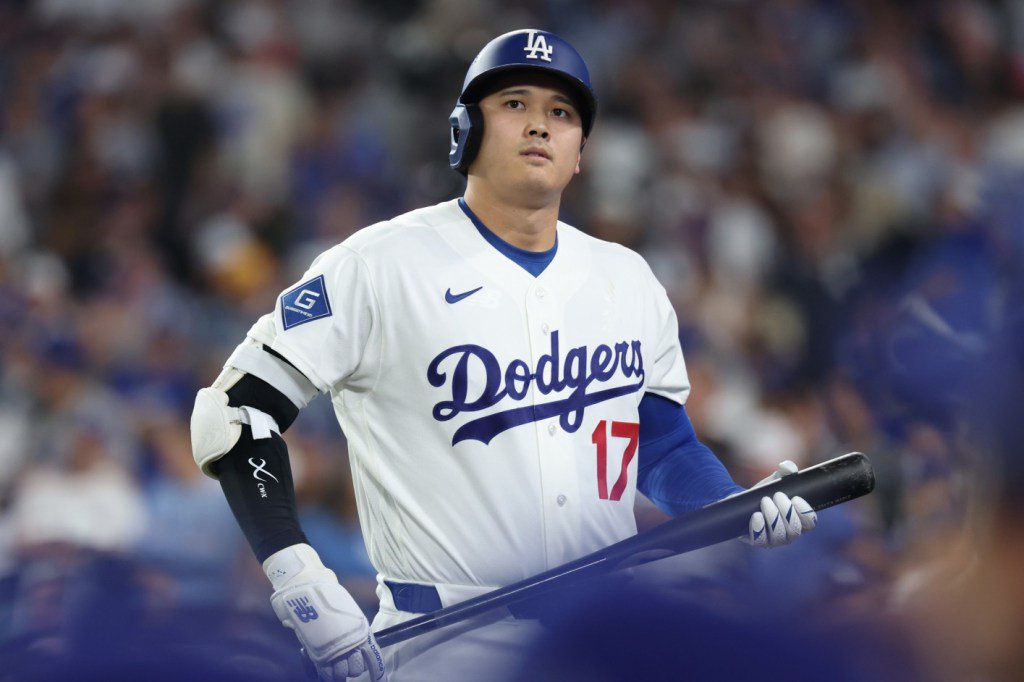 Los Angeles Dodgers player Shohei Ohtani holding a bat during Game Four of the National League Championship Series against the Milwaukee Brewers.