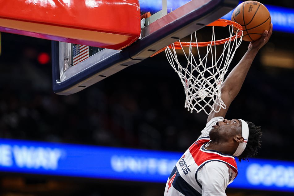 AJ Dybantsa #4 of the Washington Wizards goes to the basket against the Brooklyn Nets during the first half of a preseason game at Capital One Arena on October 12. The 19-year-old will not play in the team's season opener.