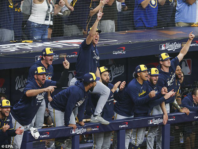 The Milwaukee Brewers dugout celebrates during their eight-run fifth inning on Monday