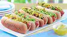 Loaded Hot Dogs sit on a plate waiting to be eaten