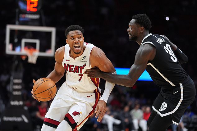 Miami Heat forward Giannis Antetokounmpo (7) comes under pressure from Brooklyn Nets forward Julius Randle (30) during the second half of an NBA preseason basketball game, Wednesday, Oct. 14, 2026, in Miami. (AP Photo/Rebecca Blackwell)