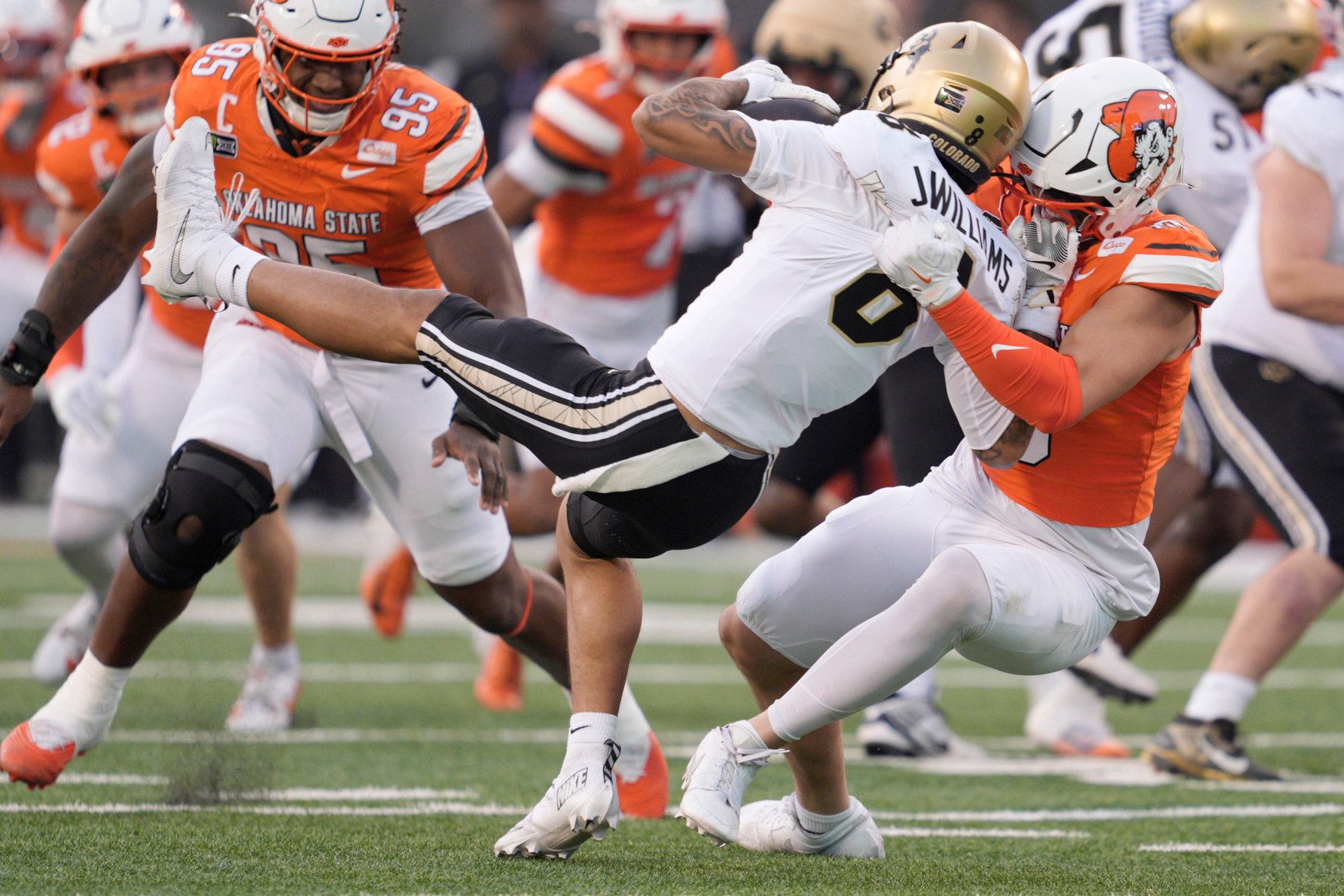 Oklahoma State Cowboys defensive end James Williams (10) brings down Colorado Buffaloes wide receiver Joseph Williams (8) during a college football game between the Oklahoma State Cowboys (OSU) and the Colorado Buffaloes at Boone Pickens Stadium in Stillwater, Okla., Saturday, Oct. 24, 2026.