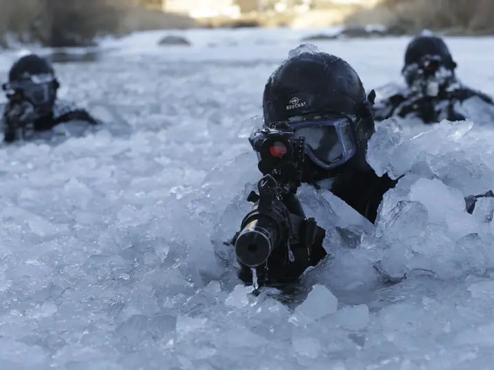 South Korea's special forces trudge through frozen river, ski with rifles in extreme winter weather training | National Post