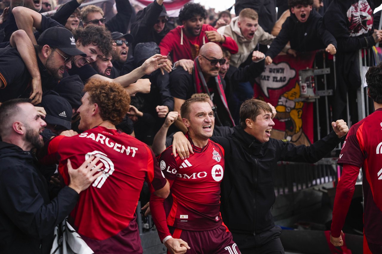 TORONTO, CANADA - OCTOBER 10: Djordje Mihailovic #10 of the Toronto FC celebrates a goal with fans after jumping the boards against the CF Montreal during the second half in their MLS match at BMO Field on October 10, 2026 in Toronto, Canada. (Photo by Mark Blinch/Getty Images)