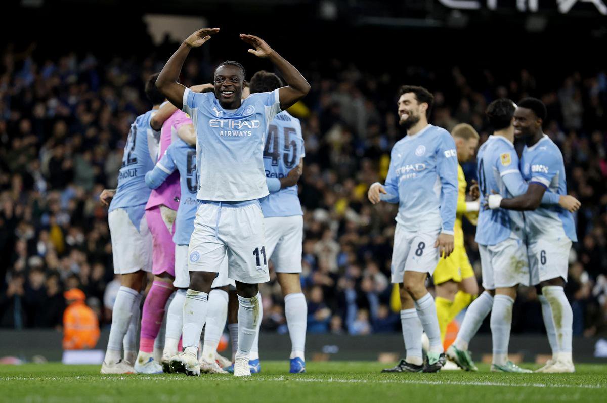 Manchester City's Jeremy Doku celebrates winning the penalty shootout against Brighton