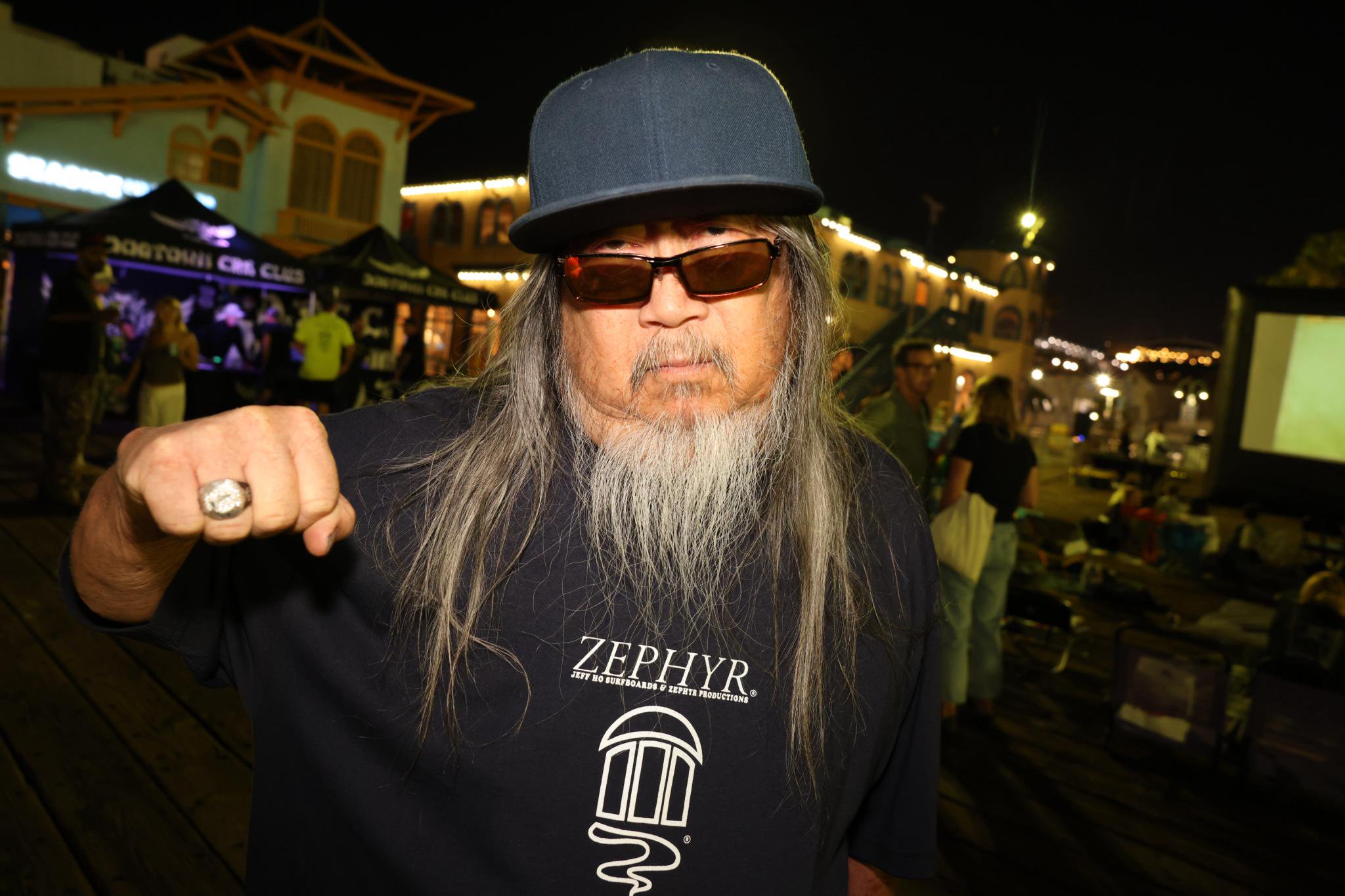 Jeff Ho wearing a Zephyr shirt and a baseball cap at the Santa Monica Pier.