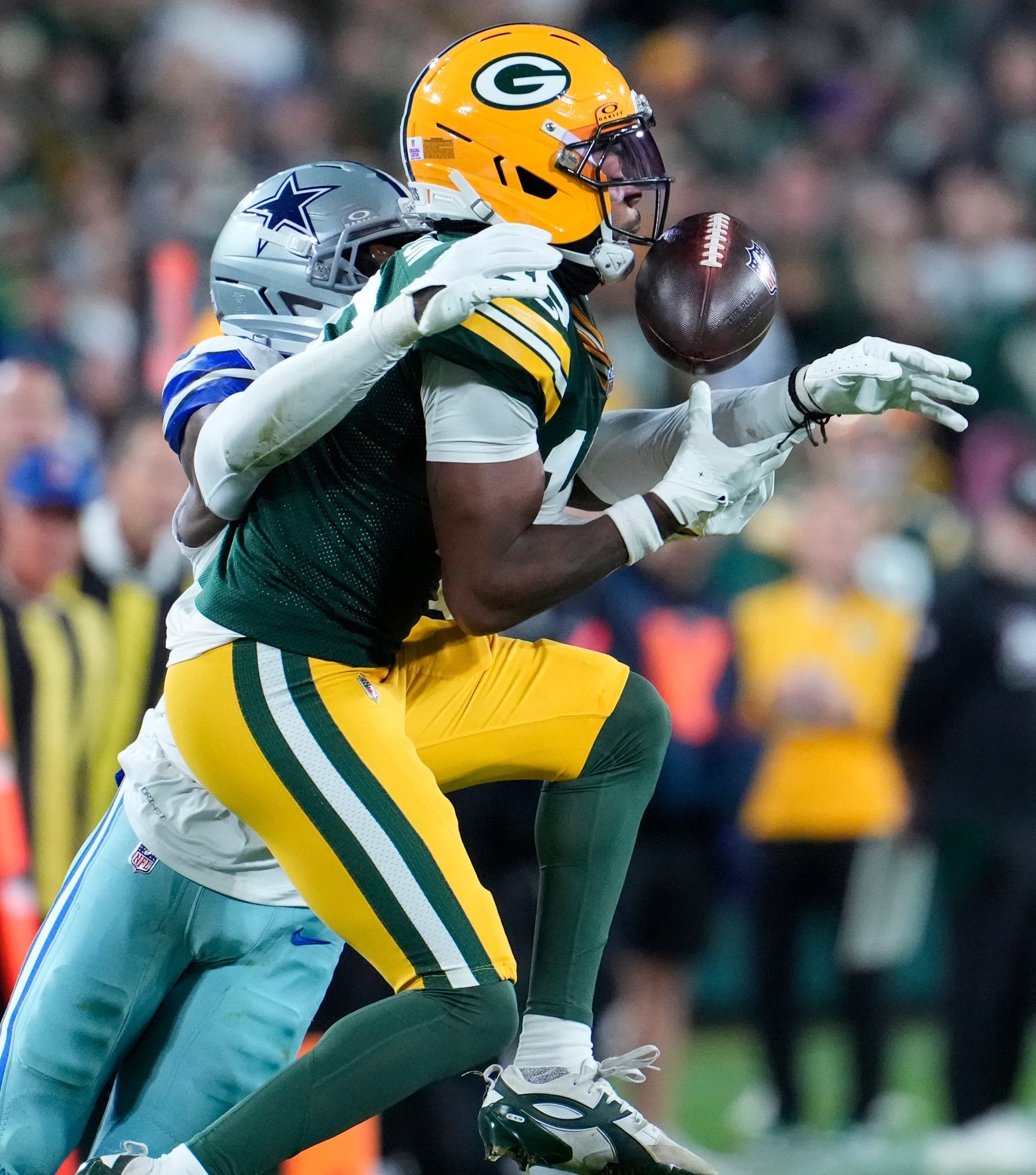 Dallas Cowboys cornerback Joey Porter Jr. (25) commits pass interference against Green Bay Packers wide receiver Bo Melton (16) during their football game Sunday, Oct. 18, 2026, at Lambeau Field in Green Bay, Wisconsin.