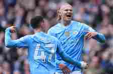 Erling Haaland (R) celebrates with Phil Foden of Manchester City