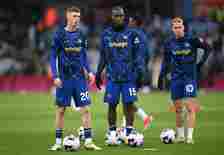 (L-R) Cole Palmer, Nicolas Jackson and Mykhaylo Mudryk of Chelsea look on during their warm up prior to the Premier League match between Aston Vill...