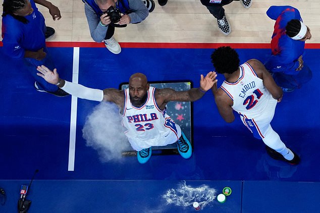 Philadelphia 76ers' LeBron James throws chalk in the air before a preseason NBA basketball game against the Boston Celtics Friday, Oct. 16, 2026, in Philadelphia. (AP Photo/Matt Slocum)