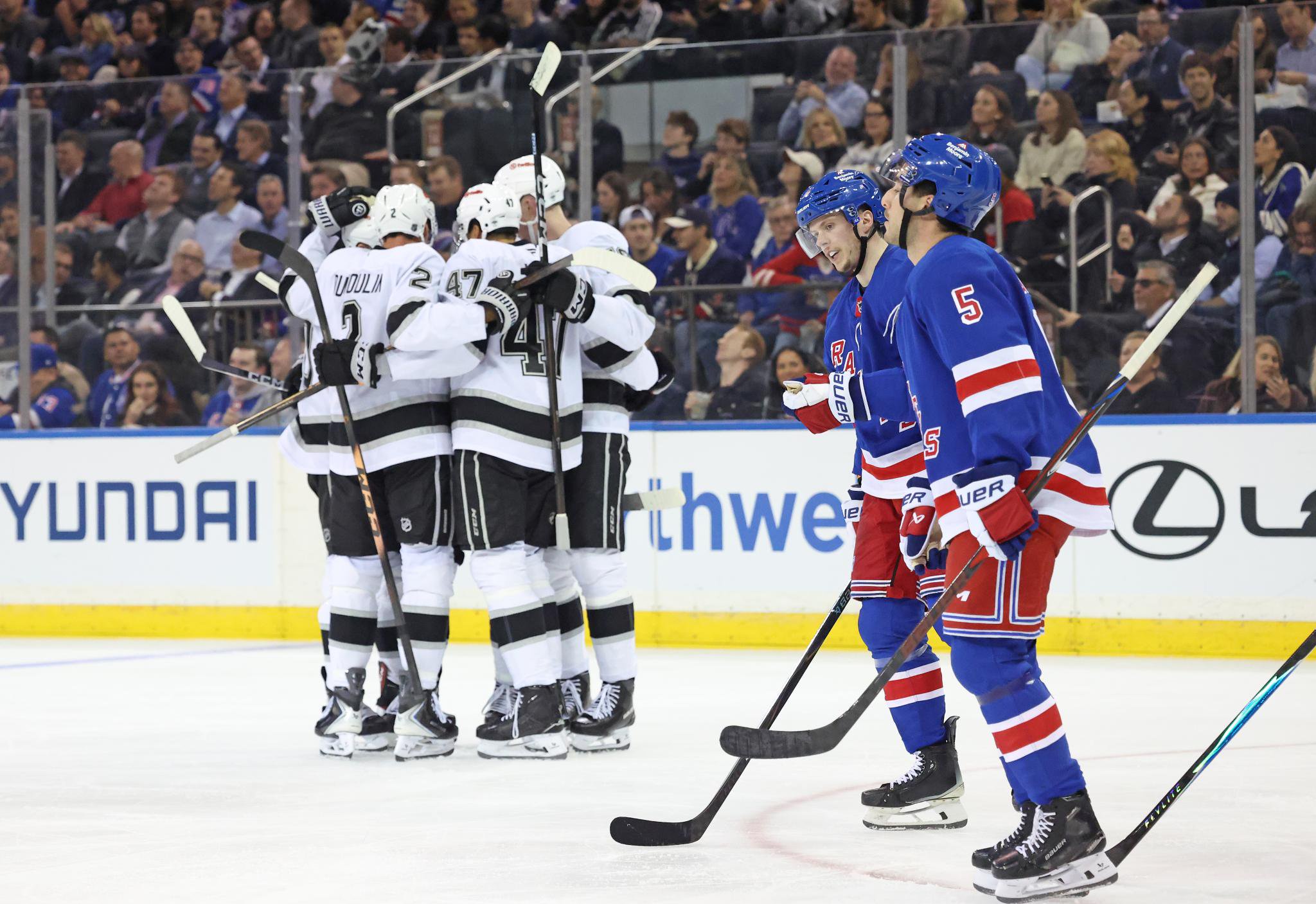 New York Rangers defenseman Sean Durzi skates past as the Los Angeles Kings celebrate a second-period goal at Madison Square Garden.
