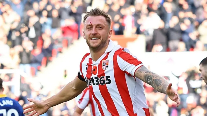 Stoke City's Ben Wilmot celebrating a goal with his arms out wide