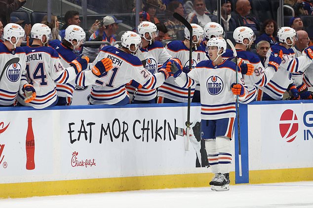 Edmonton Oilers' Ryan Nugent-Hopkins (93) reacts with teammates after scoring a goal during the second period of an NHL hockey game against the New York Islanders Saturday, Oct. 31, 2026, in Elmont, N.Y. (AP Photo/Pamela Smith)