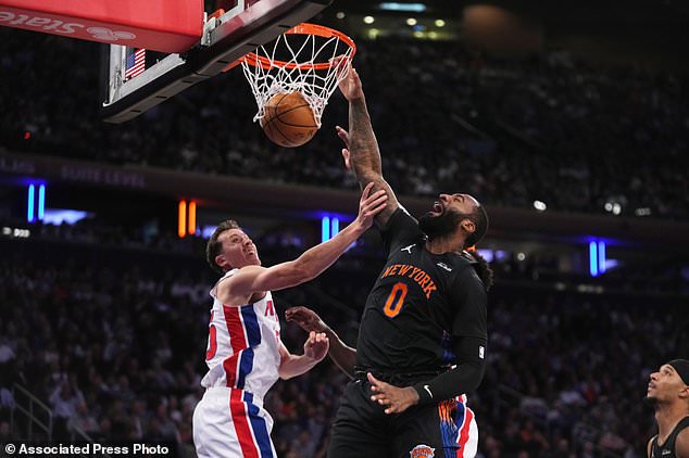 New York Knicks' Andre Drummond, right, dunks the ball in front of Detroit Pistons' Duncan Robinson during the first half of an NBA basketball game Tuesday, Oct. 27, 2026, in New York. (AP Photo/Frank Franklin II)