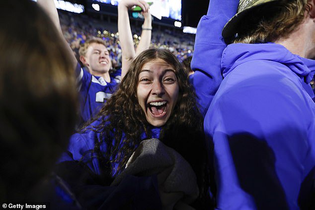 Screaming Cougars fans celebrate the team's 6-0 start following Saturday's upset