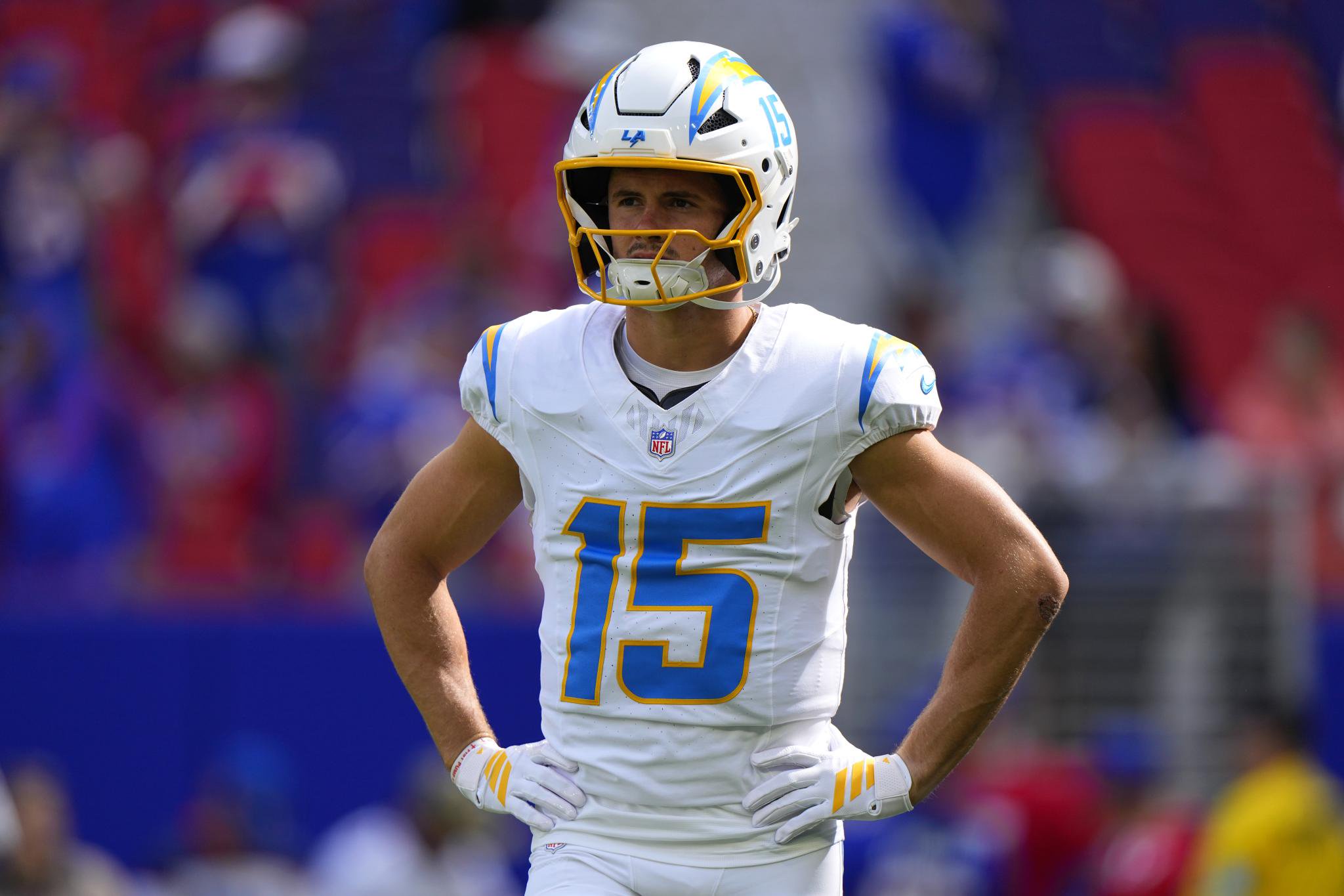 Los Angeles Chargers quarterback Easton Stick stands on the field with his hands on his hips during a game against the Buffalo Bills.