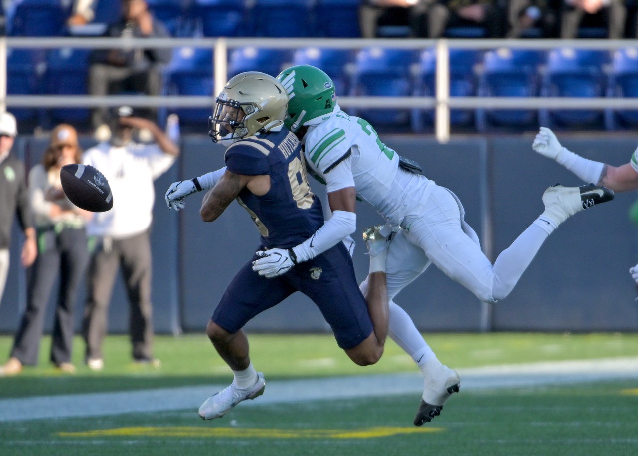 North Texas Mean Green defensive back Peyton Taylor #24 gets called for a hold on a throw to Navy Midshipmen tight end Merrick Barlow #88 in the second quarter. The Navy Midshipmen host the visiting North Texas Mean Green in an NCAA football game Saturday at Navy-Marine Corps Memorial Stadium in Annapolis. (Paul W. Gillespie/Staff)