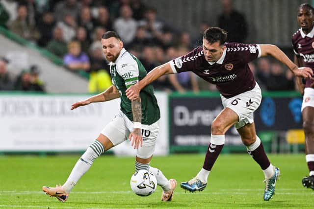 Hibernian's Martin Boyle (L) and Hearts' Oisin McEntee in action