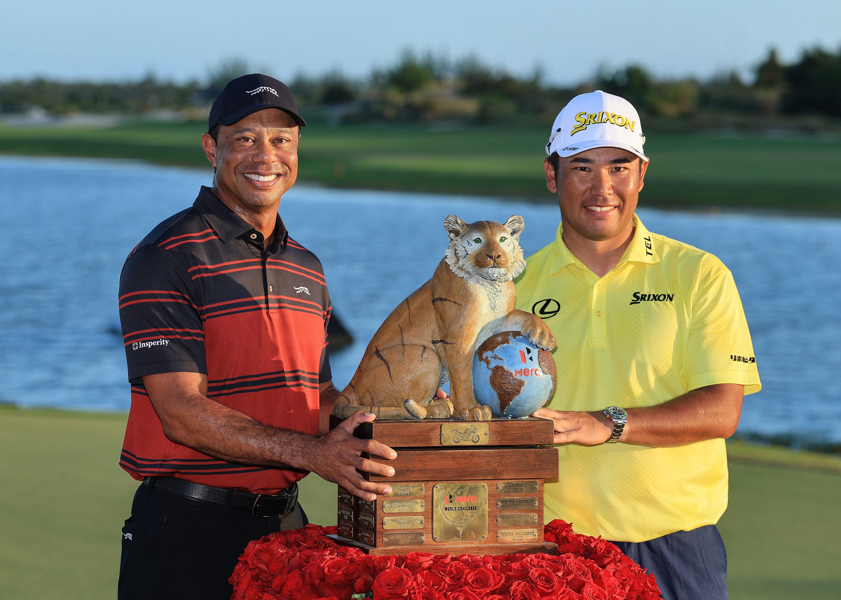 Hideki Matsuyama poses with tournament host Tiger Woods after winning the 2025 Hero World Challenge at Albany Golf Course.