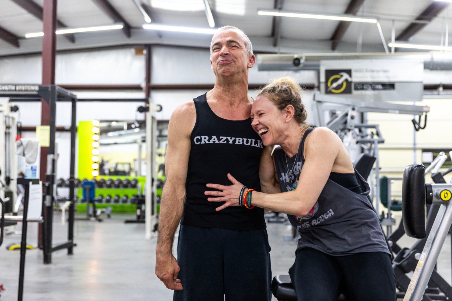 Partners Steve Alexy and Arlyn Smith come together for a portrait at Retro Flex Gym in Courtland. He has cerebral palsy; she has cerebellar ataxia. Both hold numerous powerlifting titles and even some national and world records. (Kendall Warner/The Virginian-Pilot)