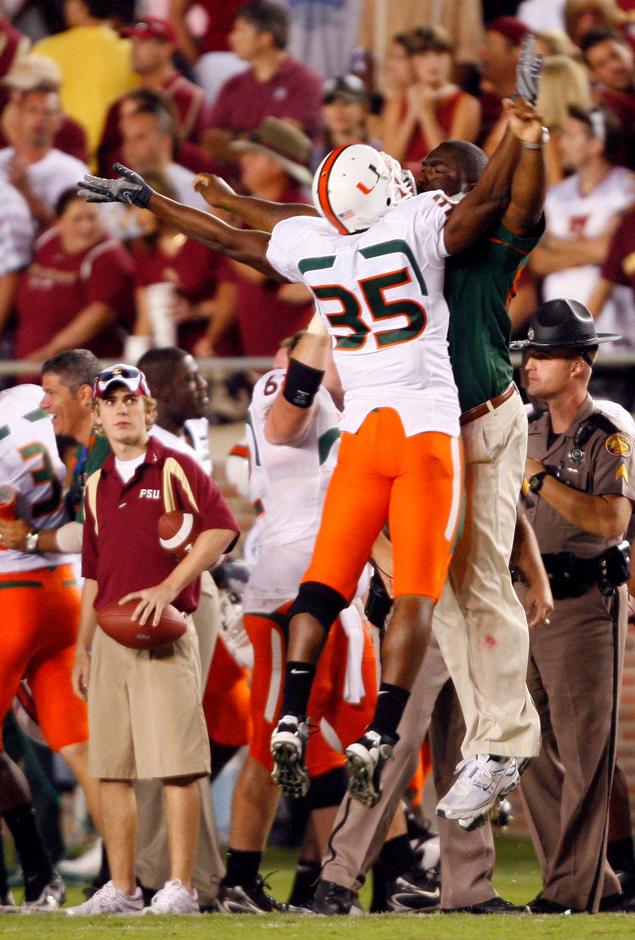 Oct 20, 2007; Tallahassee, FL, USA; Miami Hurricanes safety Lovon Ponder (35) is congratulated by a coach after the Hurricanes scored a late touchdown against the Florida State Seminoles at Doak Campbell Stadium in Tallahassee, Florida. Miami defeated Florida State 37-39. Mandatory Credit: Jason Parkhurst-USA TODAY Sports Copyright © Jason Parkhurst