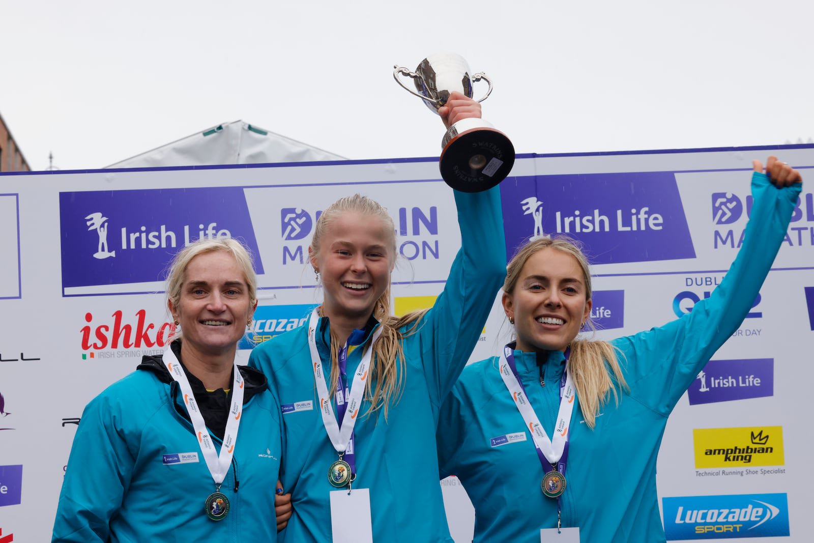 Ava Crean (centre) celebrates with second-placed Ann Marie McGlynn (left) and third-placed Nichola Sheridan after winning the national women's title at the 2025 Dublin Marathon. Photograph: Alan Betson/The Irish Times
