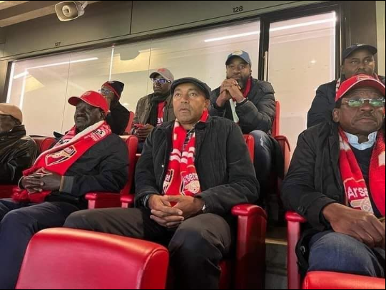 The late Raila Odinga (Left) watching Arsenal play at the Emirates Stadium previously. PHOTO/https://www.facebook.com/RailaOdingaKE