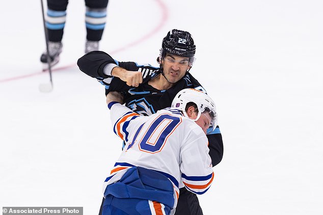 Utah Mammoth center Jack McBain (22) fights with Edmonton Oilers center Trent Frederic (10) during the first period of an NHL hockey game Saturday, Oct. 17, 2026, in Salt Lake City. (AP Photo/Melissa Majchrzak)