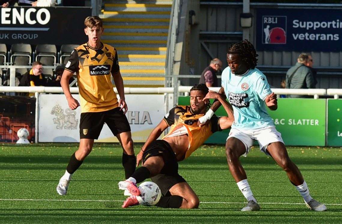 Maidstone substitute Alex Stepien-Iwumene wins possession as Leo Hamblin looks on. Picture: Steve Terrell