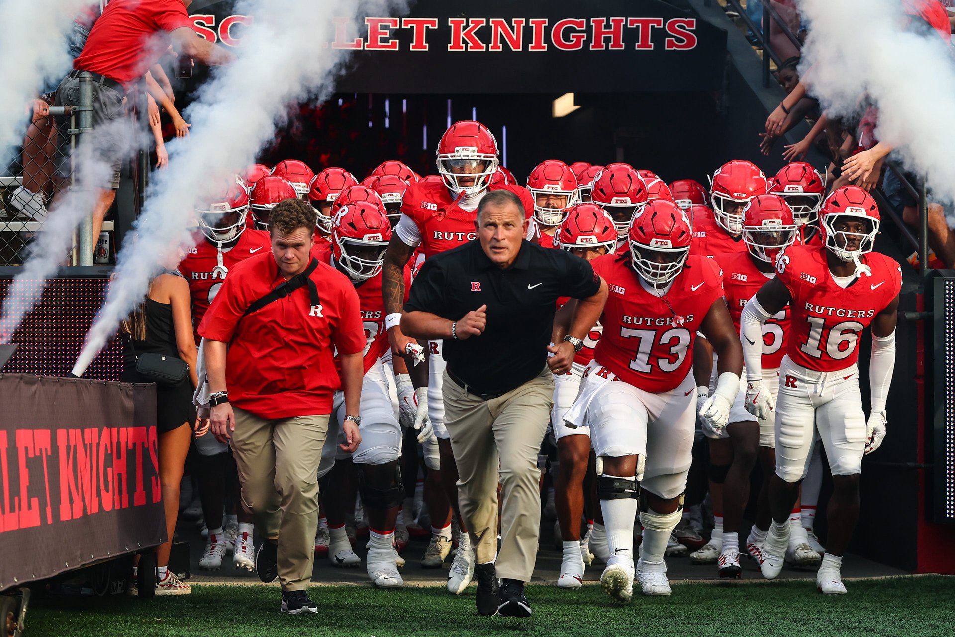 Sep 3, 2026; Piscataway, New Jersey, USA; Rutgers Scarlet Knights head coach Greg Schiano runs on to the field with his team before the game against the Massachusetts Minutemen at SHI Stadium. Mandatory Credit: Vincent Carchietta-Imagn Images