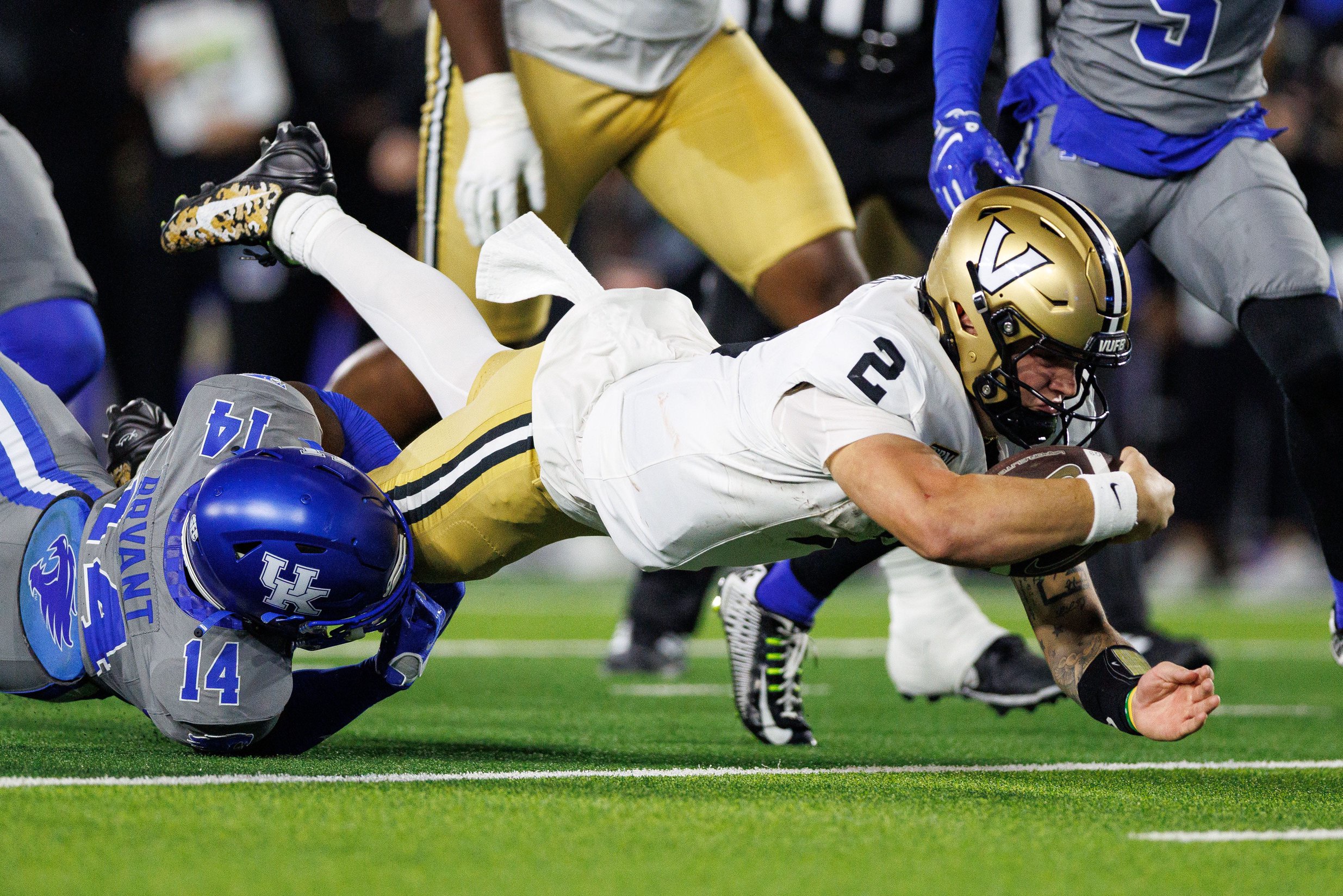Oct 24, 2026; Lexington, Kentucky, USA;  Vanderbilt Commodores quarterback Jared Curtis (2) runs the ball and is tackled by Kentucky Wildcats defensive back Ty Bryant (14) during the second quarter at Kroger Field.  Mandatory Credit: Jordan Prather-Imagn Images