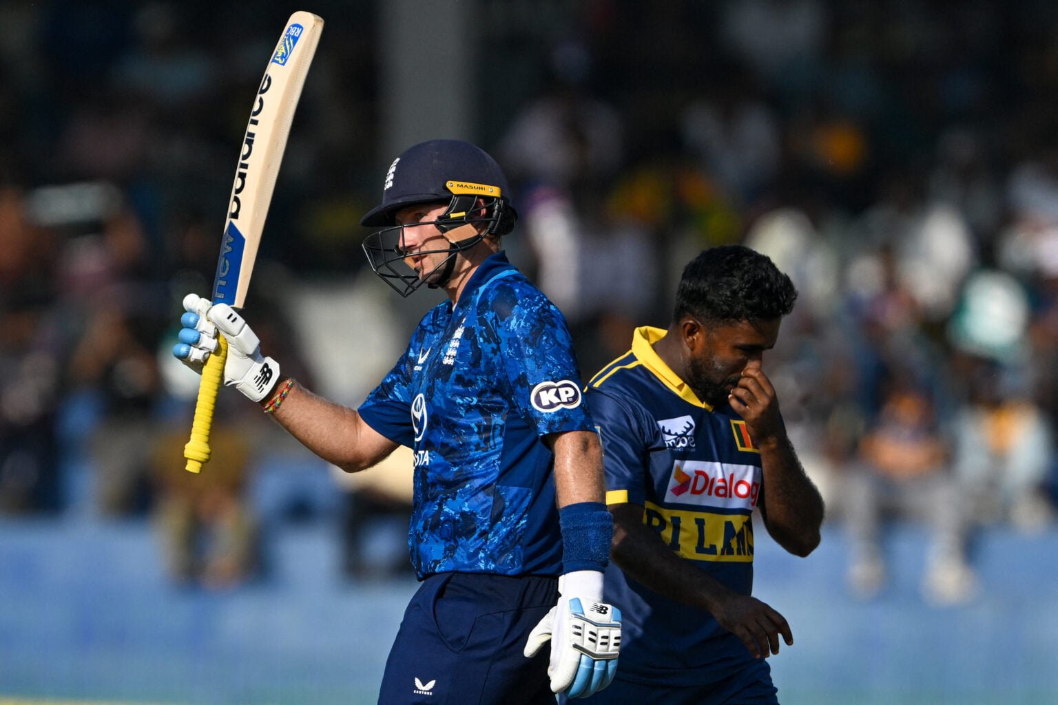 England's Joe Root (L) celebrates after scoring a half-century (50 runs) during the third one-day international (ODI) cricket match between Sri Lanka and England