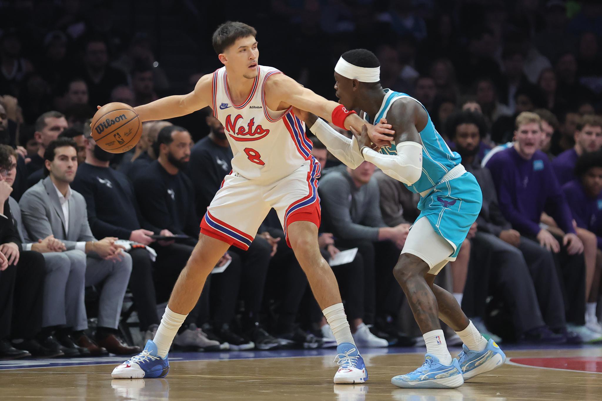 Brooklyn Nets guard Egor Demin (8) controls the ball against Charlotte Hornets guard Dennis Schroder (17).