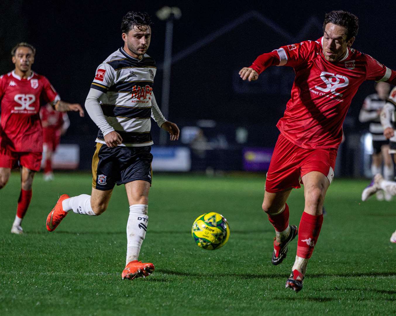 Jack Penny, of Deal Town, is beaten to the ball by Faversham Town's Jack Evans. Picture: Nathan Munday
