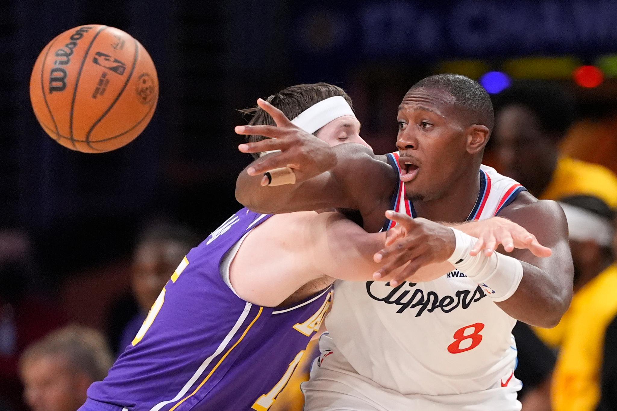 Kris Dunn and Austin Reaves battle for the ball during a game.