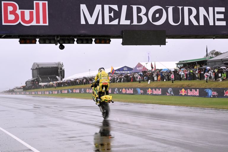 Prima Pramac Yamaha MotoGP's Australian rider Jack Miller pulls a wheelie as he takes part in a farewell lap following the cancellation of the last Australian MotoGP Grand Prix to be held at Phillip Island on October 25, 2026, due to inclement weather conditions.