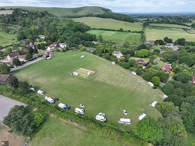Caravans parked around the outside of Clayton Recreation Ground - prompting local cricket club Burgess Hill to joke there were 'more fielders in the deep than usual'