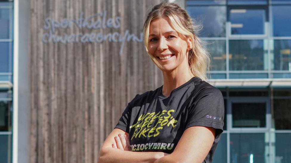 Becky North smiles outside Sport Wales in Cardiff