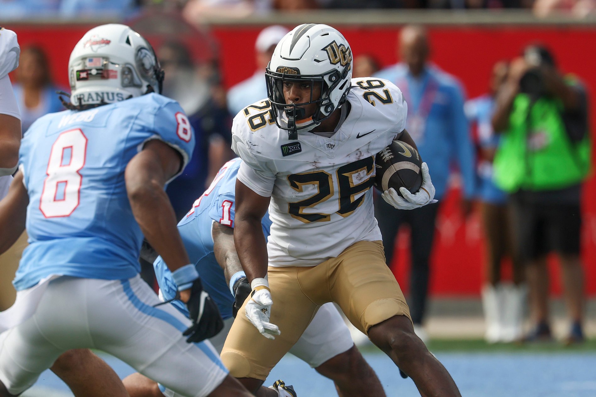 Oct 3, 2026; Houston, Texas, USA; UCF Knights running back Duke Watson (26) runs with the ball during the first quarter against the Houston Cougars at TDECU Stadium. Mandatory Credit: Troy Taormina-Imagn Images