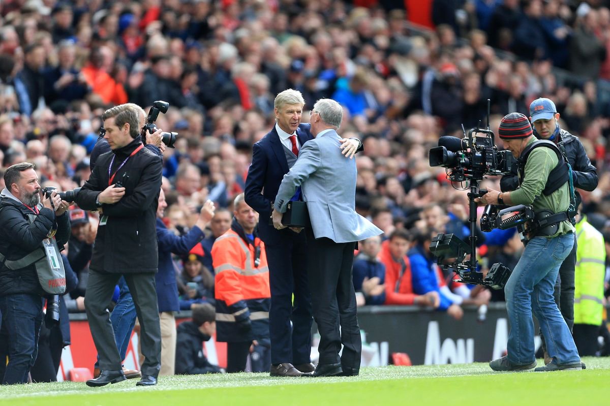 Former Man Utd manager Sir Alex Ferguson greets Arsenal manager Arsene Wenger and presents him with a gift ahead of the Premier League match between Manchester United and Arsenal at Old Trafford