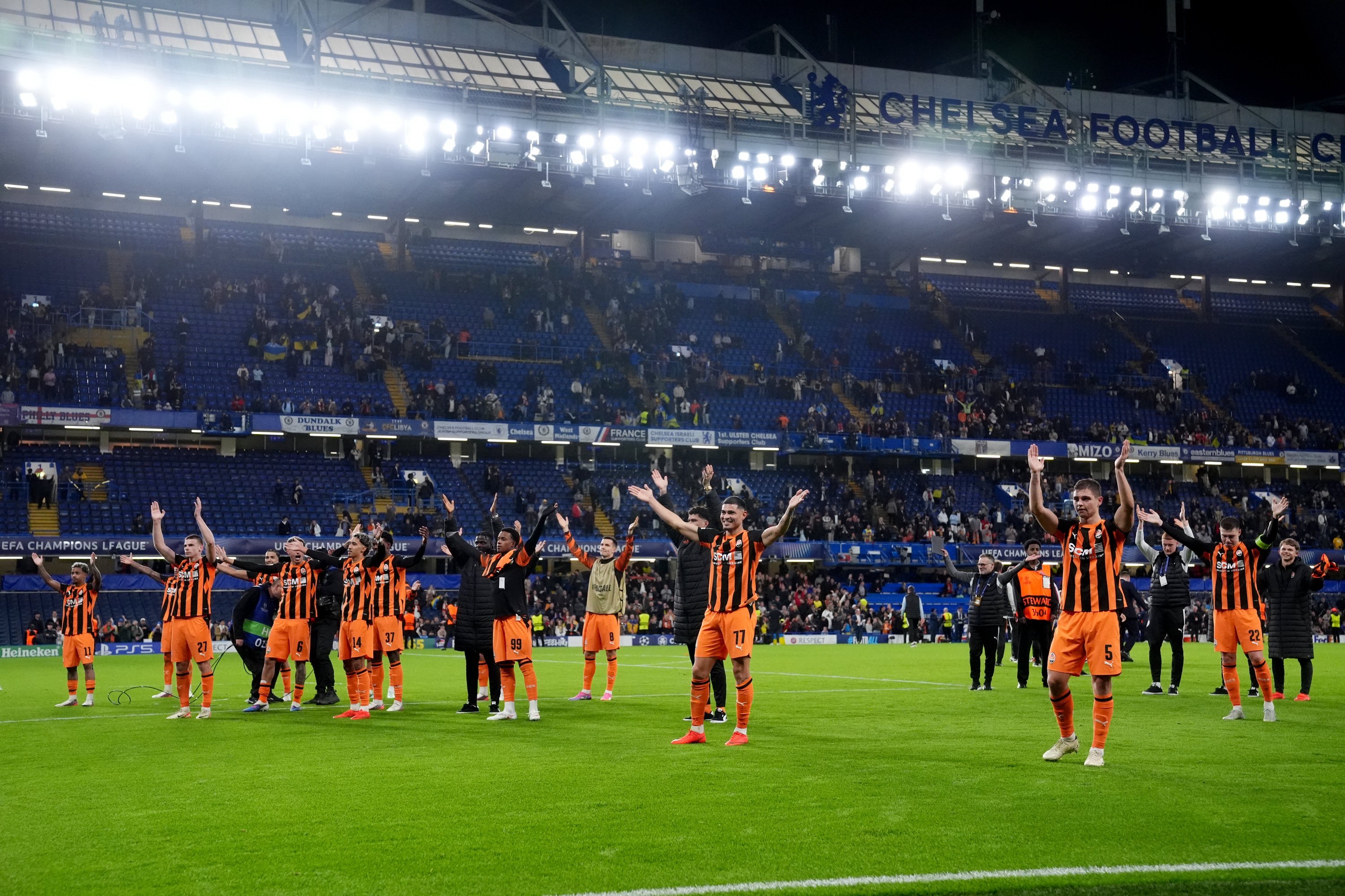 Shakhtar players lead a 'Viking Thunder Clap' celebration with their supporters after their victory