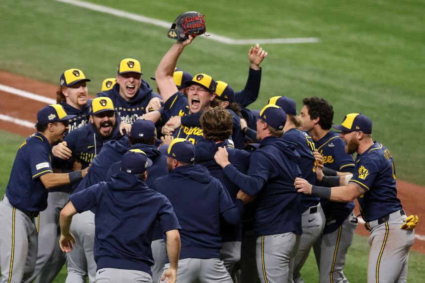 The Milwaukee Brewers celebrate with Trevor Megill after the final out of the World Series.