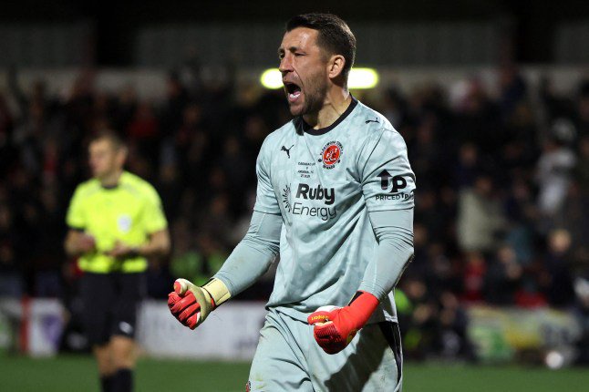 Fleetwood Town's English goalkeeper #01 Jay Lynch celebrates after saving a penalty shot from Arsenal's Brazilian midfielder #39 Bruno Guimar??es (unseen) during a penalty shoot out following a 1-1 draw in the English League Cup fourth round football match between Fleetwood Town and Arsenal at Highbury Stadium in Fleetwood, north west England, on October 27, 2026. Fleetwood won the match 5-3 following a penalty shoot out. (Photo by Darren Staples / AFP via Getty Images) / RESTRICTED TO EDITORIAL USE. No use with unauthorized audio, video, data, fixture lists, club/league logos or 'live' services. Online in-match use limited to 120 images. An additional 40 images may be used in extra time. No video emulation. Social media in-match use limited to 120 images. An additional 40 images may be used in extra time. No use in betting publications, games or single club/league/player publications. /