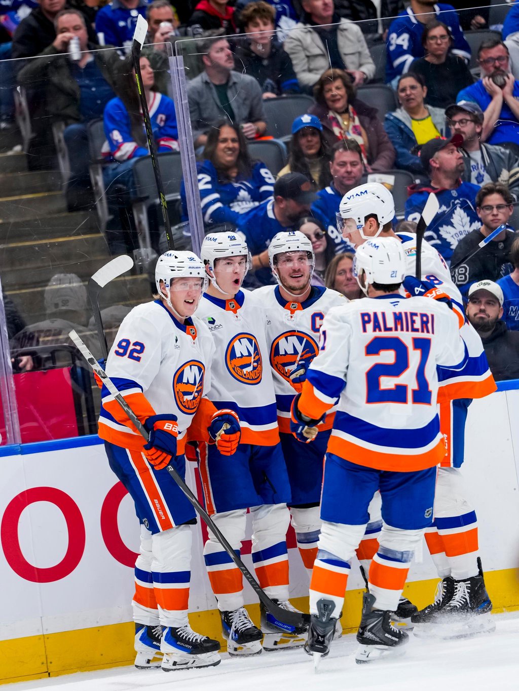 Simon Holmstrom (92) and teammates celebrate a goal for the New York Islanders.