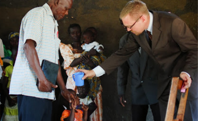  Eric Tuininga baptising a child earlier