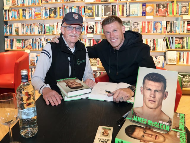Professional footballer James McClean signing his autobiography, “The Walls” in Waterstones, Foyleside, for  former professional football and former Derry City manager, Tony O'Doherty.