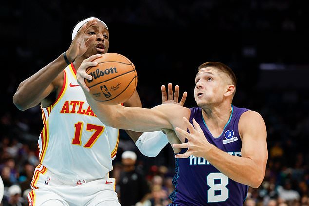 Charlotte Hornets guard Grayson Allen (8) drives to the basket against Atlanta Hawks forward Onyeka Okongwu (17) during the first half of an NBA basketball game in Charlotte, N.C., Friday, Oct. 23, 2026. (AP Photo/Nell Redmond)